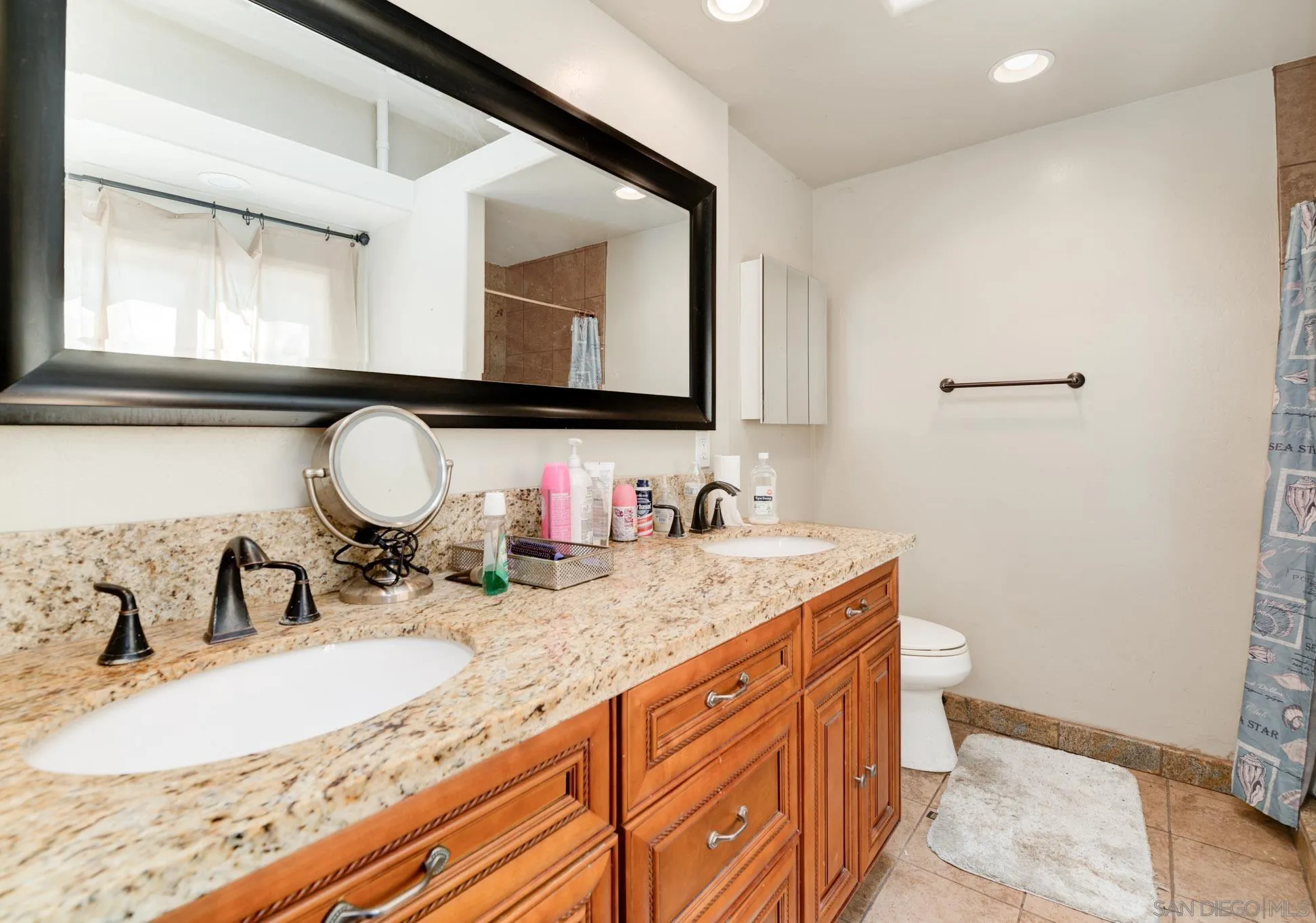 30015 Ridge Creek Road Valley Center, CA 92082 - Photo 13 of 59 a bathroom with a granite countertop sink a mirror and vanity