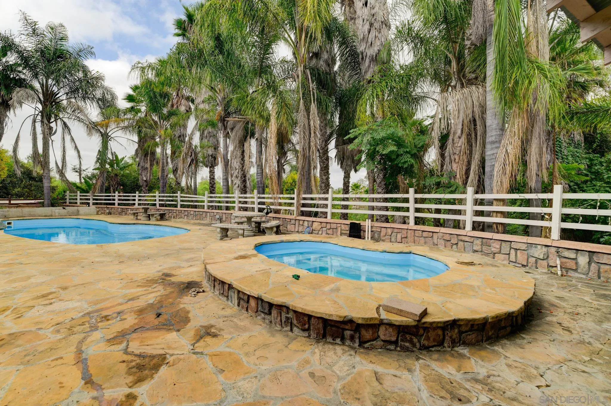 30015 Ridge Creek Road Valley Center, CA 92082 - Photo 34 of 59 a view of a swimming pool with a patio and palm trees