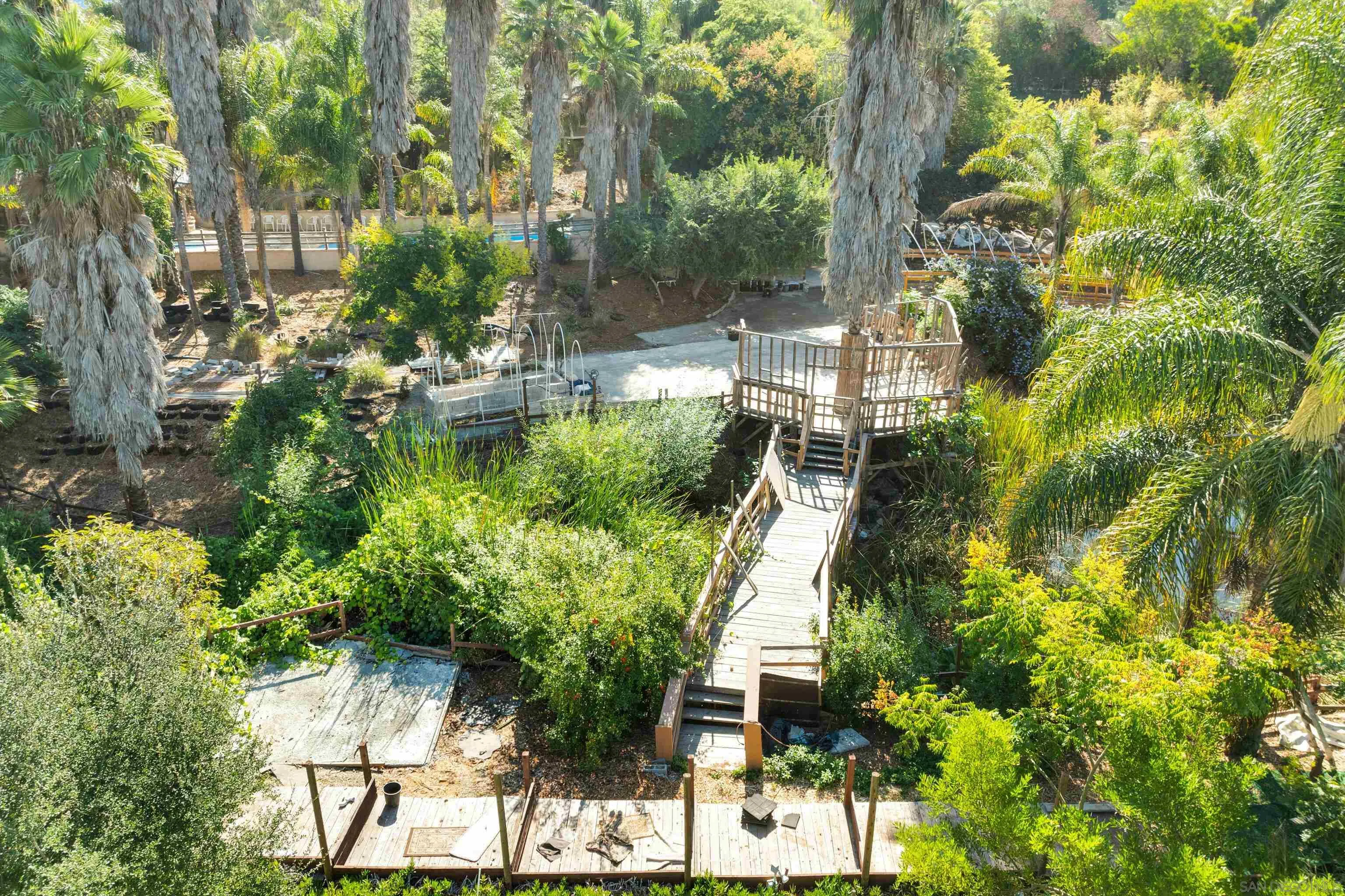 30015 Ridge Creek Road Valley Center, CA 92082 - Photo 37 of 59 a view of backyard with table and chairs and potted plants