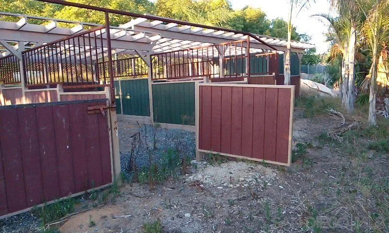 30015 Ridge Creek Road Valley Center, CA 92082 - Photo 57 of 59 a view of a small barn with wooden fence