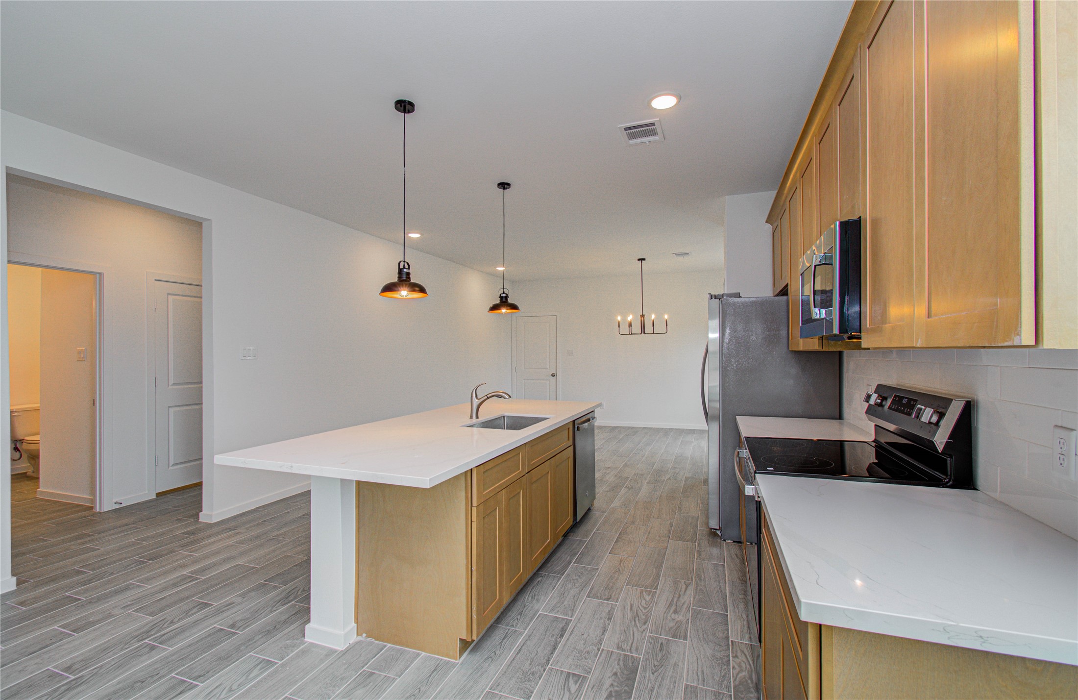 211 19th Hempstead, TX 77445 - Photo 10 of 21 Kitchen
Modern kitchen with white quartz countertops, stainless steel appliances, and ample cabinet space.