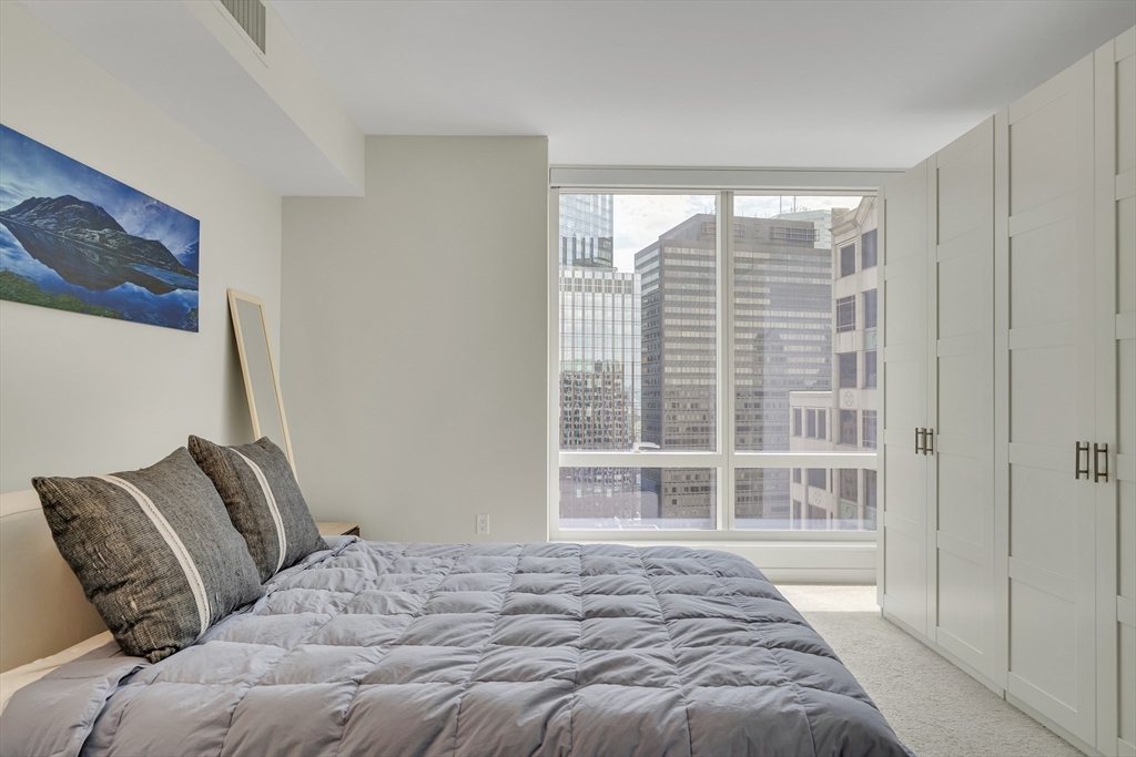 1 Franklin Street, Unit 2409 Boston, MA 02110 - Photo 11 of 19 a bedroom with a bed and a window