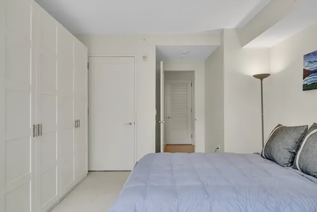 a bedroom with a bed and a closet