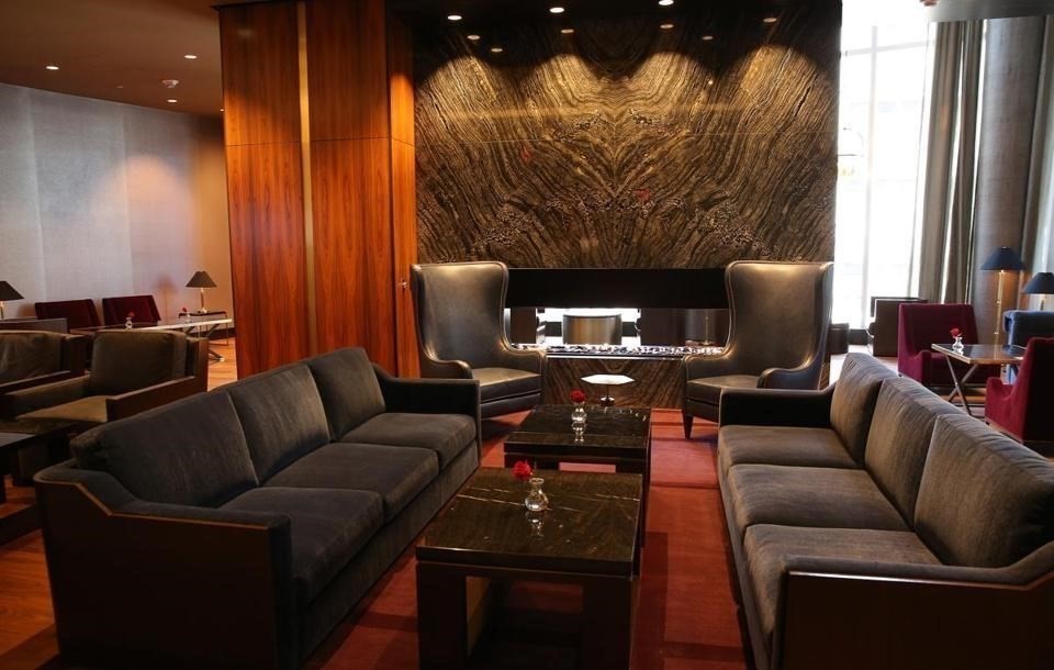 1 Franklin Street, Unit 2409 Boston, MA 02110 - Photo 16 of 19 a living room with furniture and a fireplace