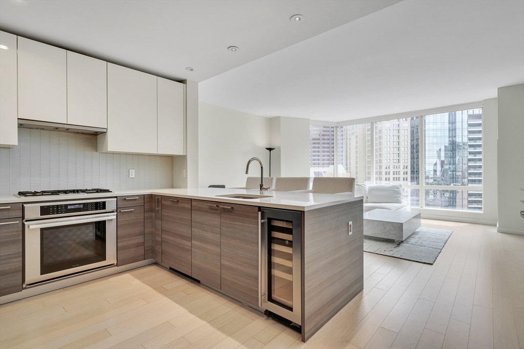 1 Franklin Street, Unit 2409 Boston, MA 02110 - Photo 2 of 19 a kitchen with a sink stove and cabinets