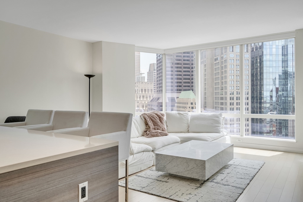 1 Franklin Street, Unit 2409 Boston, MA 02110 - Photo 6 of 19 a living room with furniture and a large window