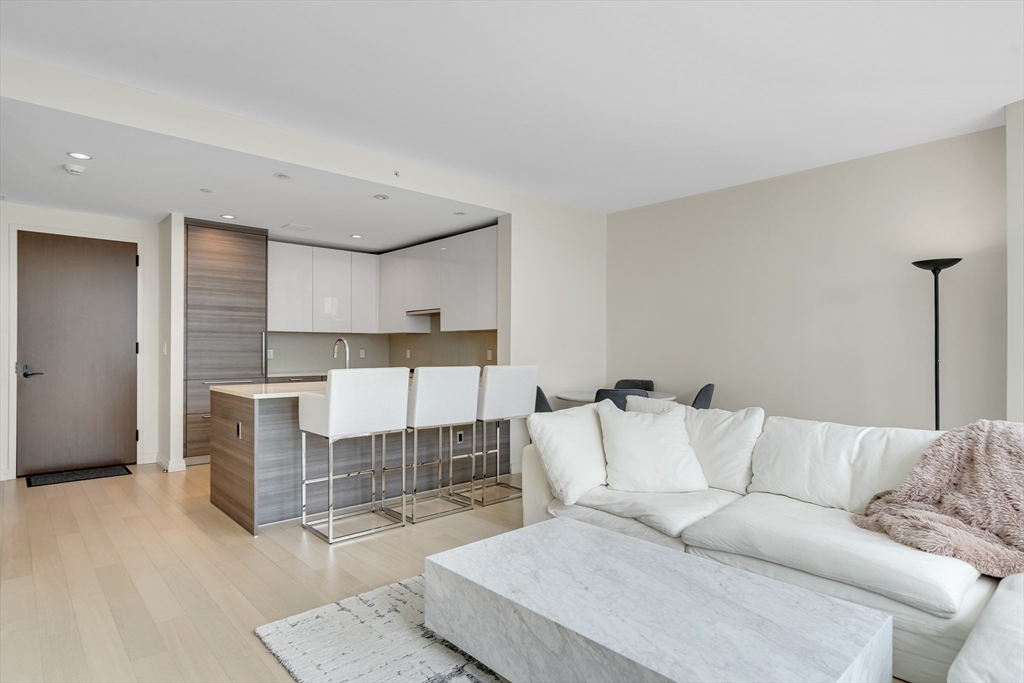 1 Franklin Street, Unit 2409 Boston, MA 02110 - Photo 7 of 19 a living room with furniture and a rug