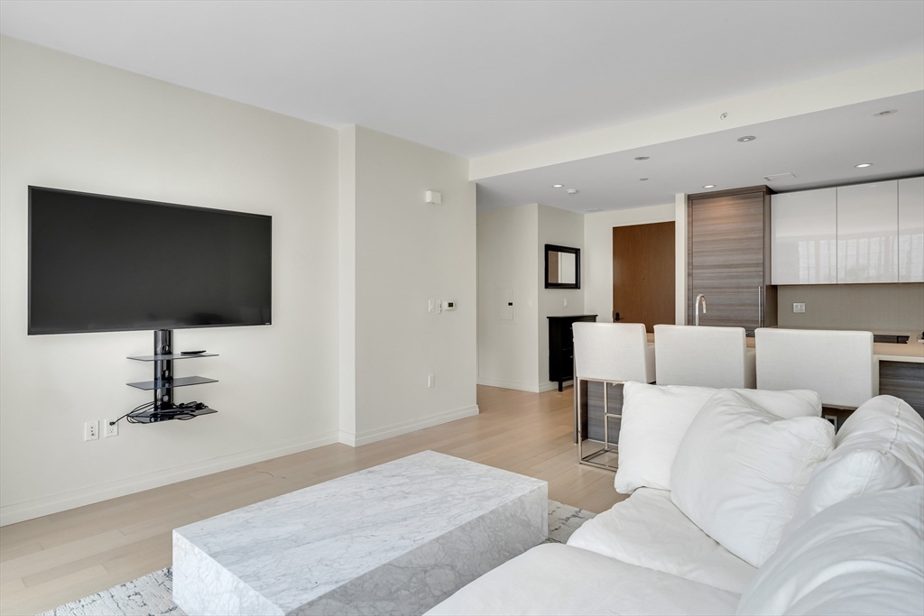 1 Franklin Street, Unit 2409 Boston, MA 02110 - Photo 8 of 19 a living room with couches and a flat screen tv