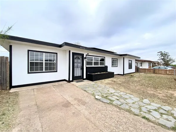 a view of house with yard and balcony