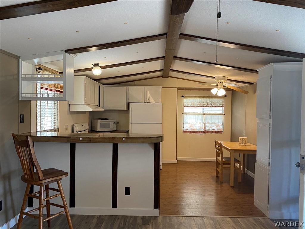 1709 Talc Road Bullhead City, AZ 86442 - Photo 5 of 29 a kitchen with granite countertop a stove a table and chairs in it