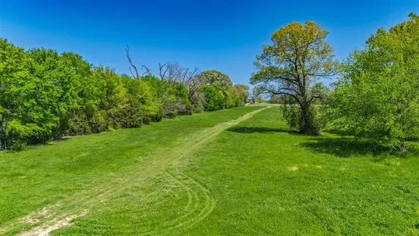 a view of a big yard with a house and a yard
