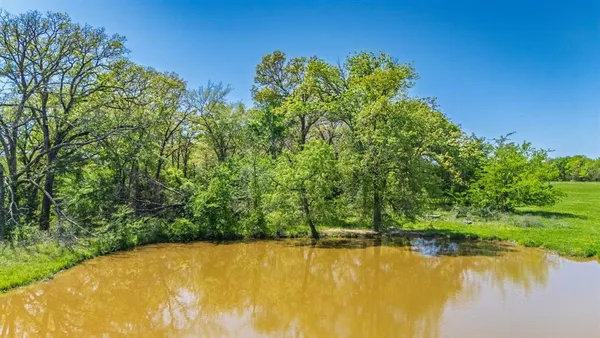 a view of a lake with a yard