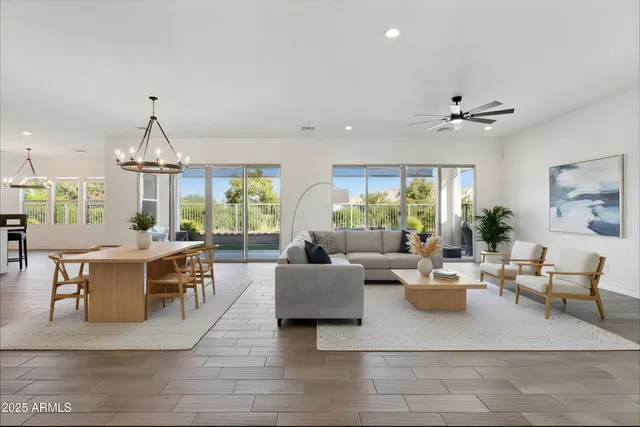a living room with furniture a chandelier and a table
