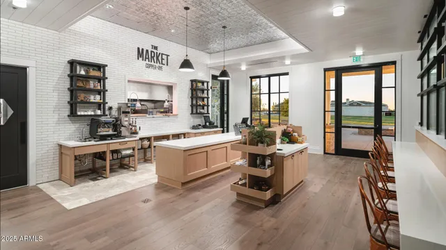 a large white kitchen with stainless steel appliances granite countertop a stove and a large window