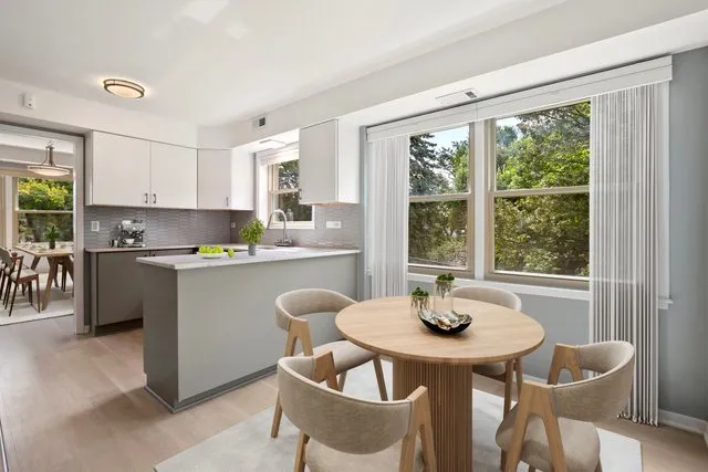 a kitchen with a table chairs sink and cabinets