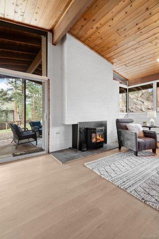 a view of a livingroom with furniture and fireplace