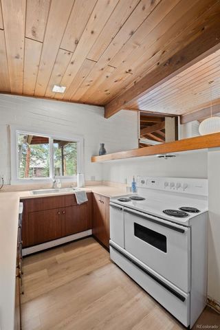a kitchen with stainless steel appliances a stove a sink and a refrigerator