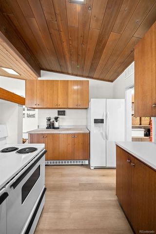 a kitchen with a stove a sink and a refrigerator