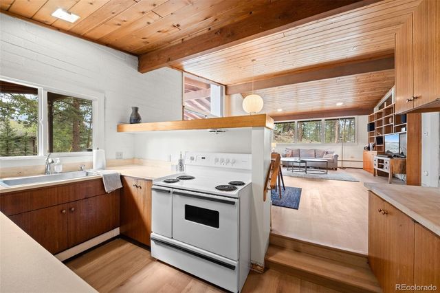 a kitchen with a sink stove and cabinets