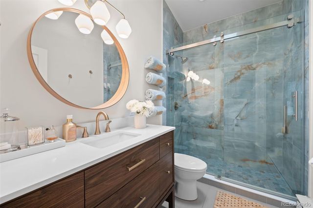 a bathroom with a double vanity sink toilet and a mirror