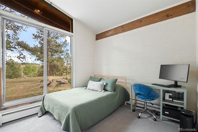 a bedroom with a large bed and a large window