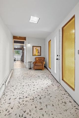 a spacious bedroom with a bed and a dresser