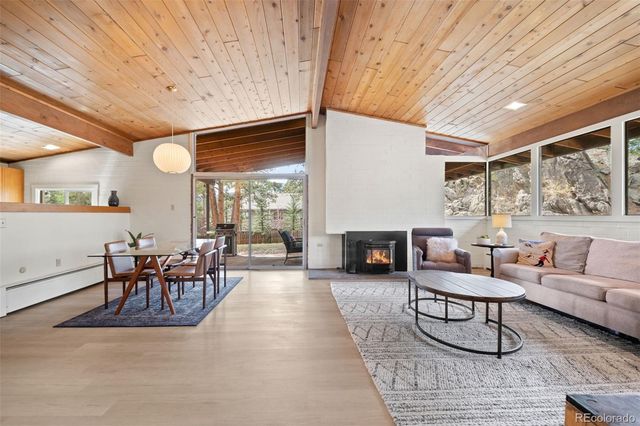 a living room with furniture a fireplace and a table