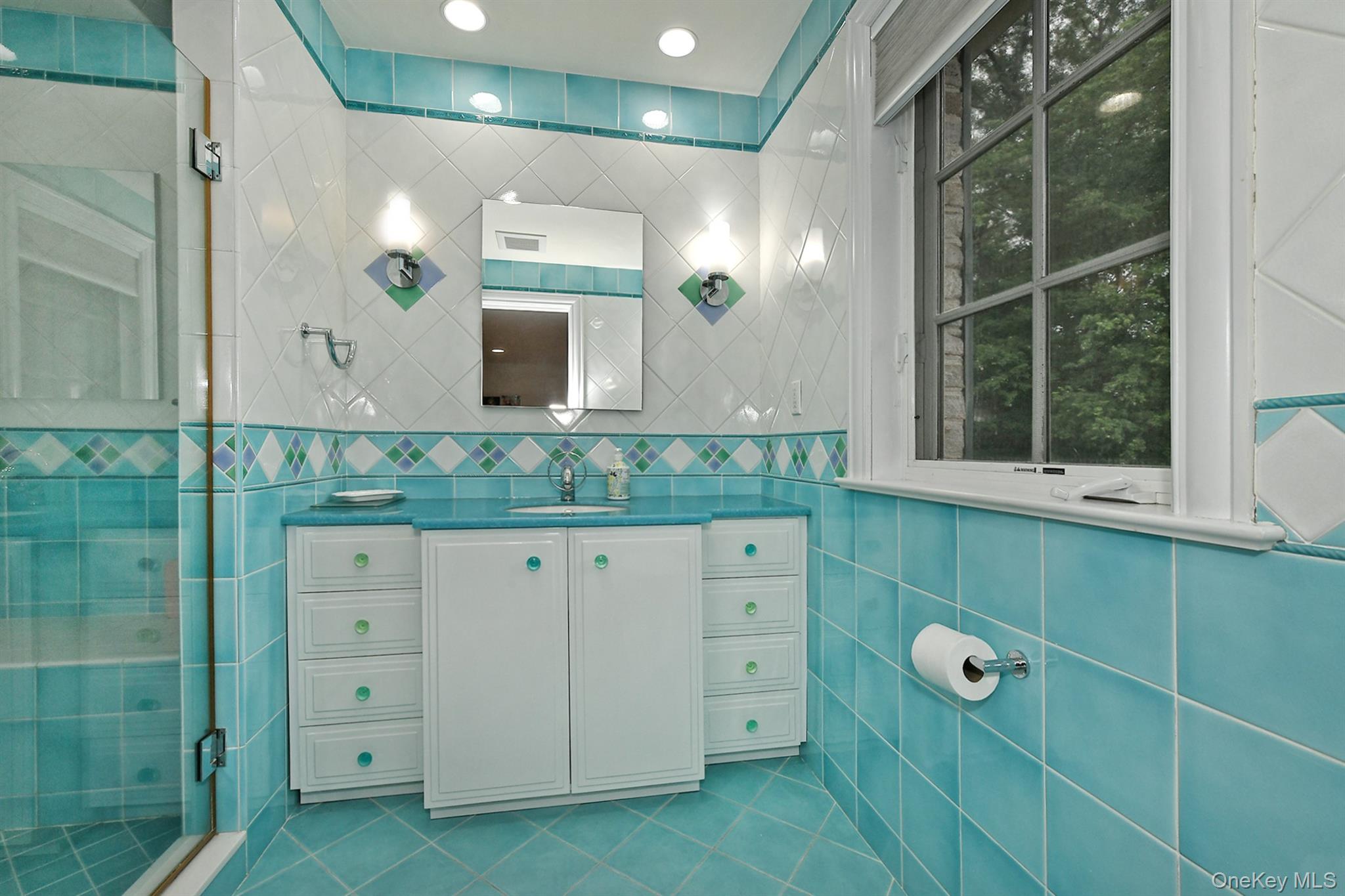 14 Norgate Road Glen Head, NY 11545 - Photo 31 of 44 a bathroom with a granite countertop sink mirror and window