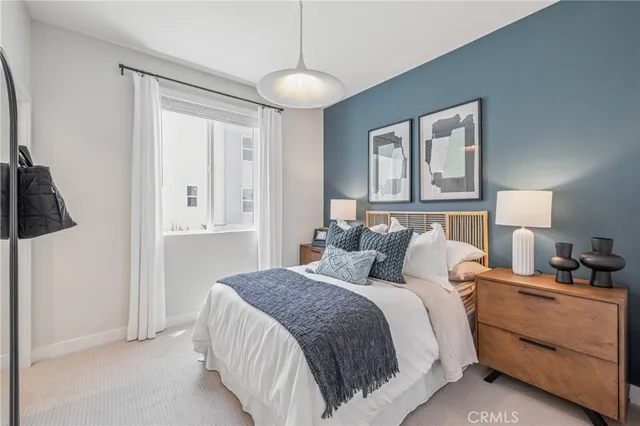 a bedroom with a bed and closet with wooden floor