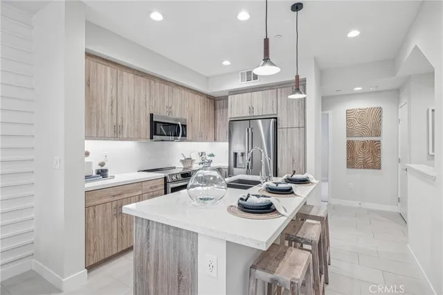 a kitchen with a sink a stove and chairs
