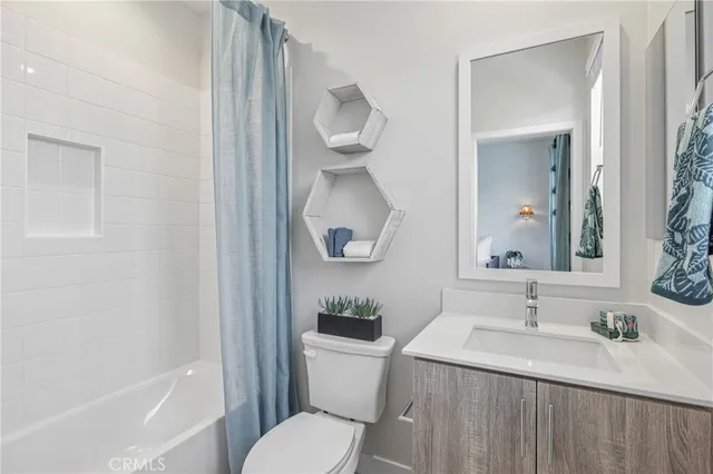 a bathroom with a sink vanity granite toilet and a mirror
