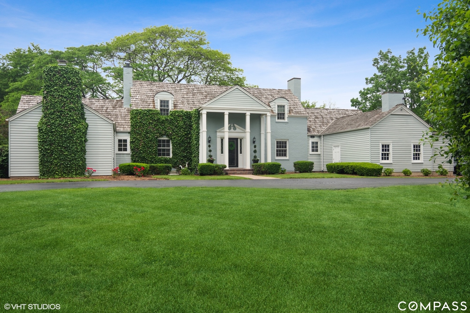 a front view of a house with a garden