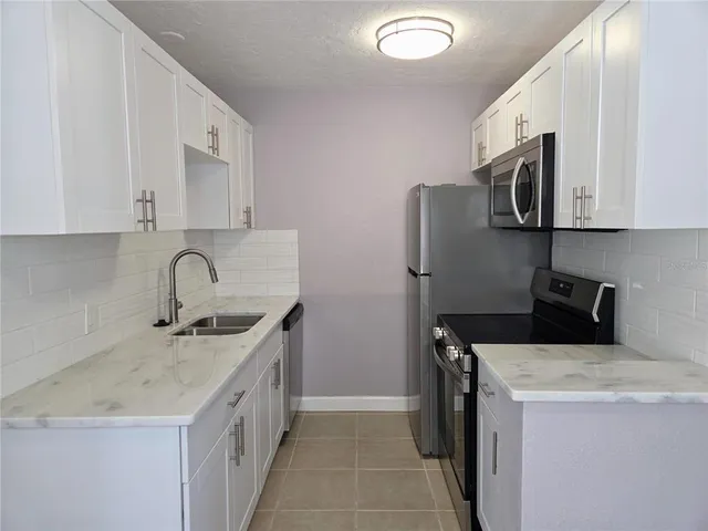 a utility room with sink dryer and washer