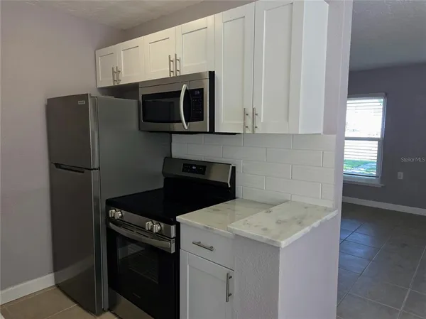a kitchen with a stove and a microwave