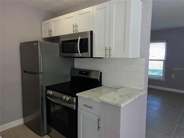 a kitchen with a stove and a microwave