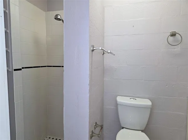a bathroom with a toilet and a shower