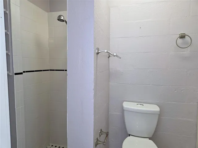 a bathroom with a toilet and a shower