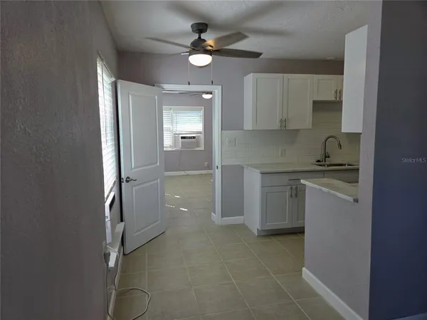 a kitchen with kitchen island a sink stainless steel appliances and cabinets