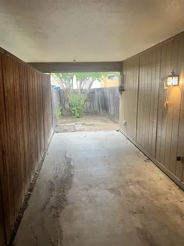 an empty room with floor to ceiling windows and an empty room