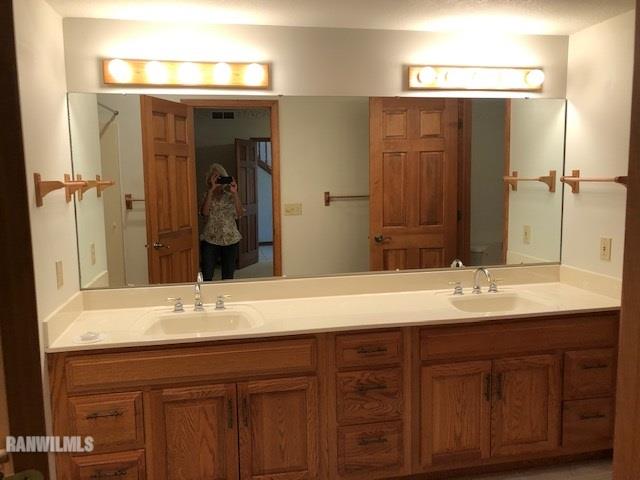 8 Heatherdowns Lane Galena, IL 61036 - Photo 15 of 39 a bathroom with a granite countertop sink and a mirror