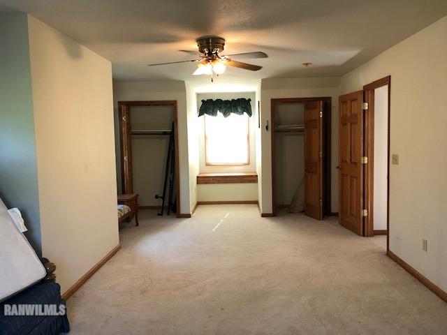 8 Heatherdowns Lane Galena, IL 61036 - Photo 25 of 39 an empty room with windows and a ceiling fan