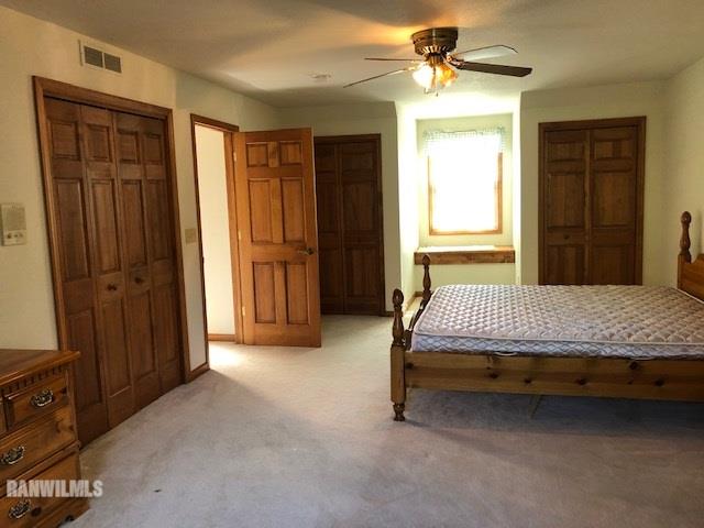 8 Heatherdowns Lane Galena, IL 61036 - Photo 28 of 39 a bedroom with a bed dresser and a chandelier
