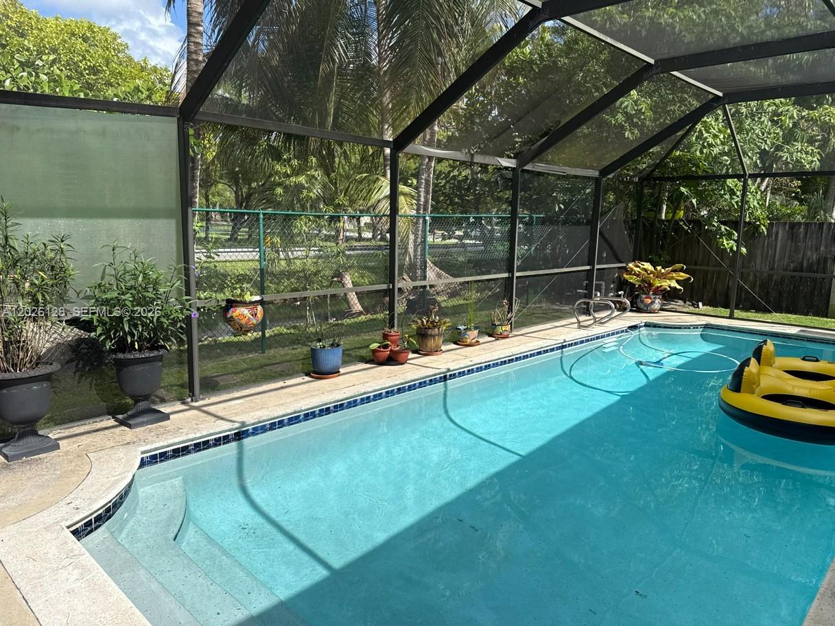 8040 Southwest 63rd Place Miami, FL 33143 - Photo 8 of 15 a swimming pool with outdoor seating and yard