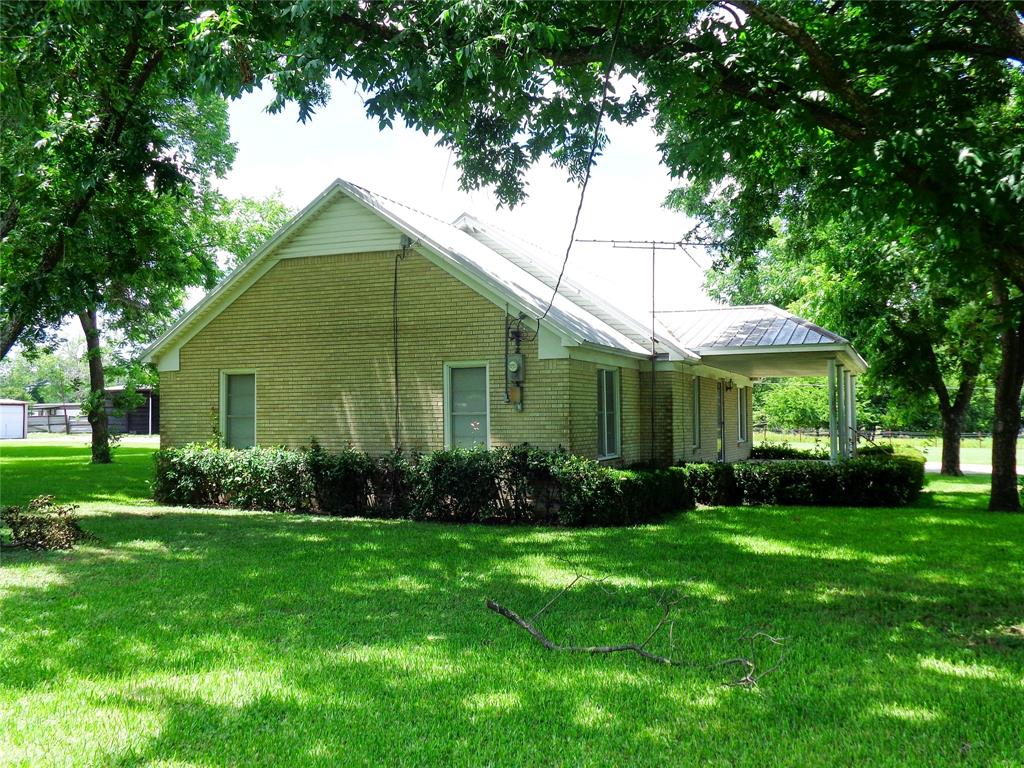 1717 Pipeline Road Cleburne, TX 76033 - Photo 22 of 33 Brick exterior with a metal roof, featuring a covered porch with white columns