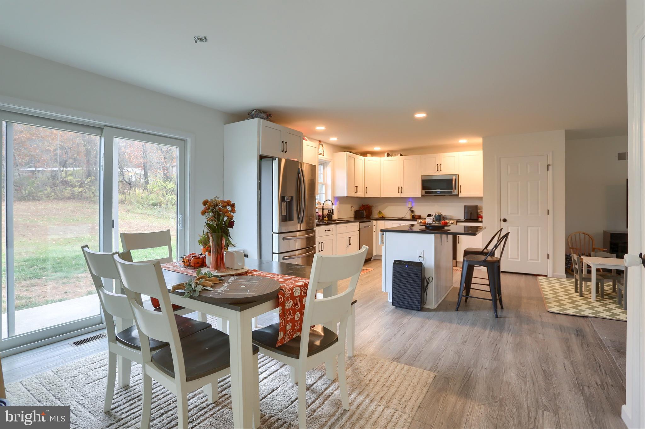405 Small Valley Road Halifax, PA 17032 - Photo 13 of 36 a kitchen with a table chairs refrigerator and microwave