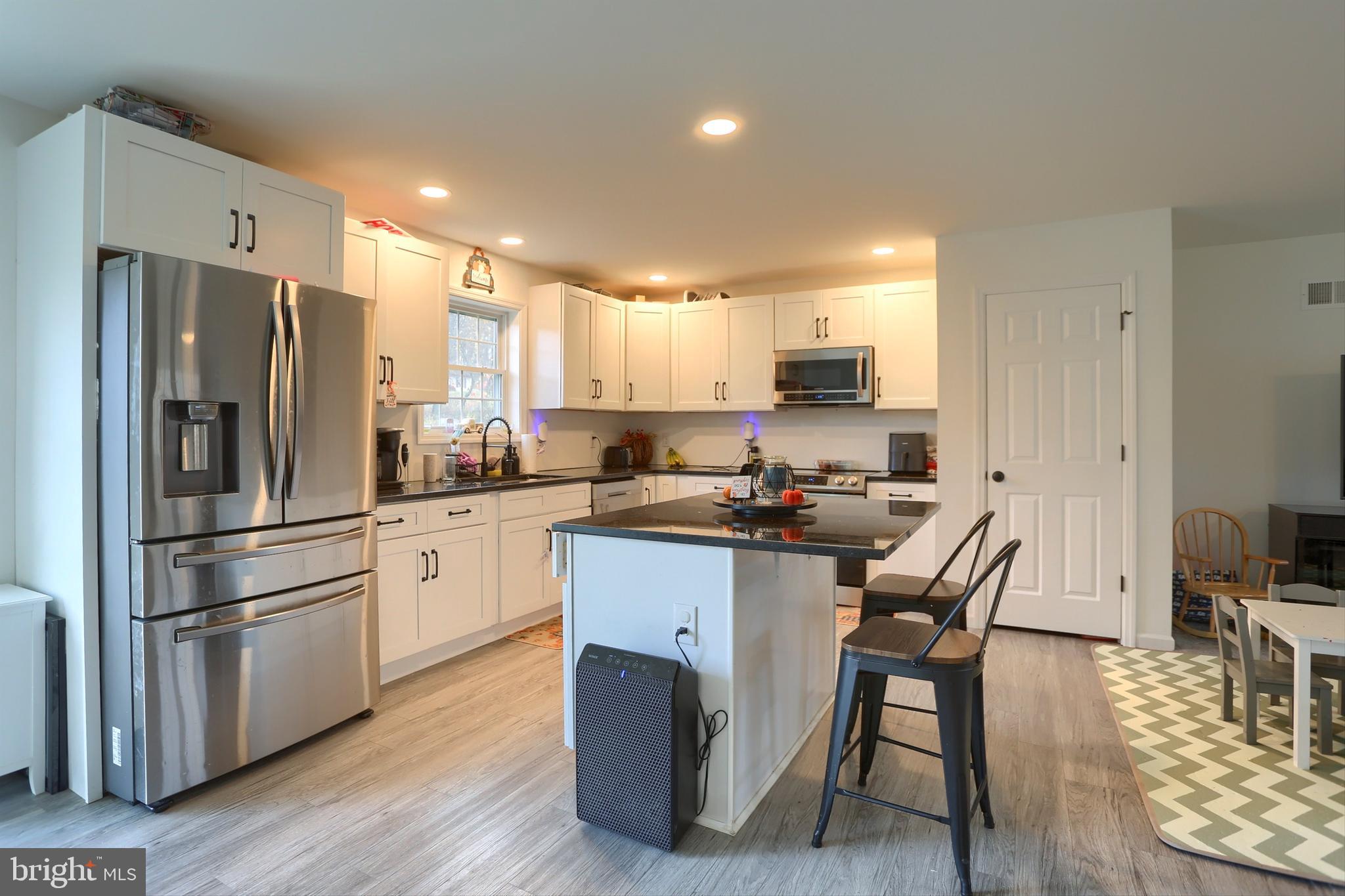 405 Small Valley Road Halifax, PA 17032 - Photo 14 of 36 a kitchen with stainless steel appliances a refrigerator a stove a sink dishwasher and a refrigerator with wooden floor