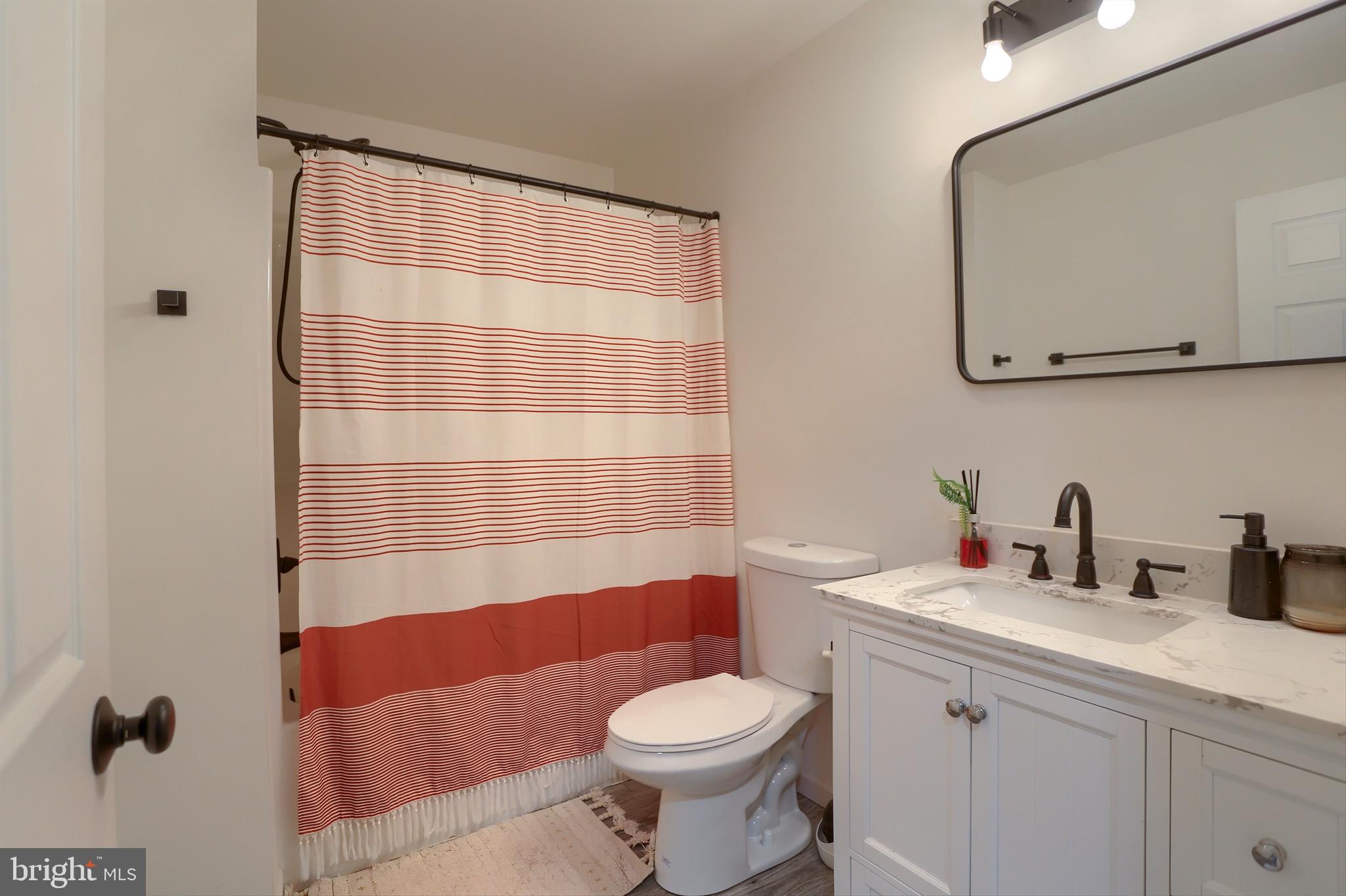 405 Small Valley Road Halifax, PA 17032 - Photo 20 of 36 a bathroom with a sink a toilet and shower curtain