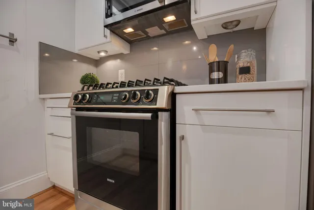 a close view of a stove top oven sitting inside of a kitchen