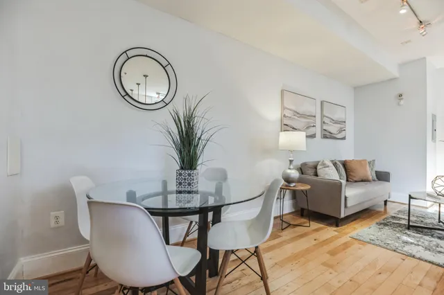 a dining room with furniture and wooden floor