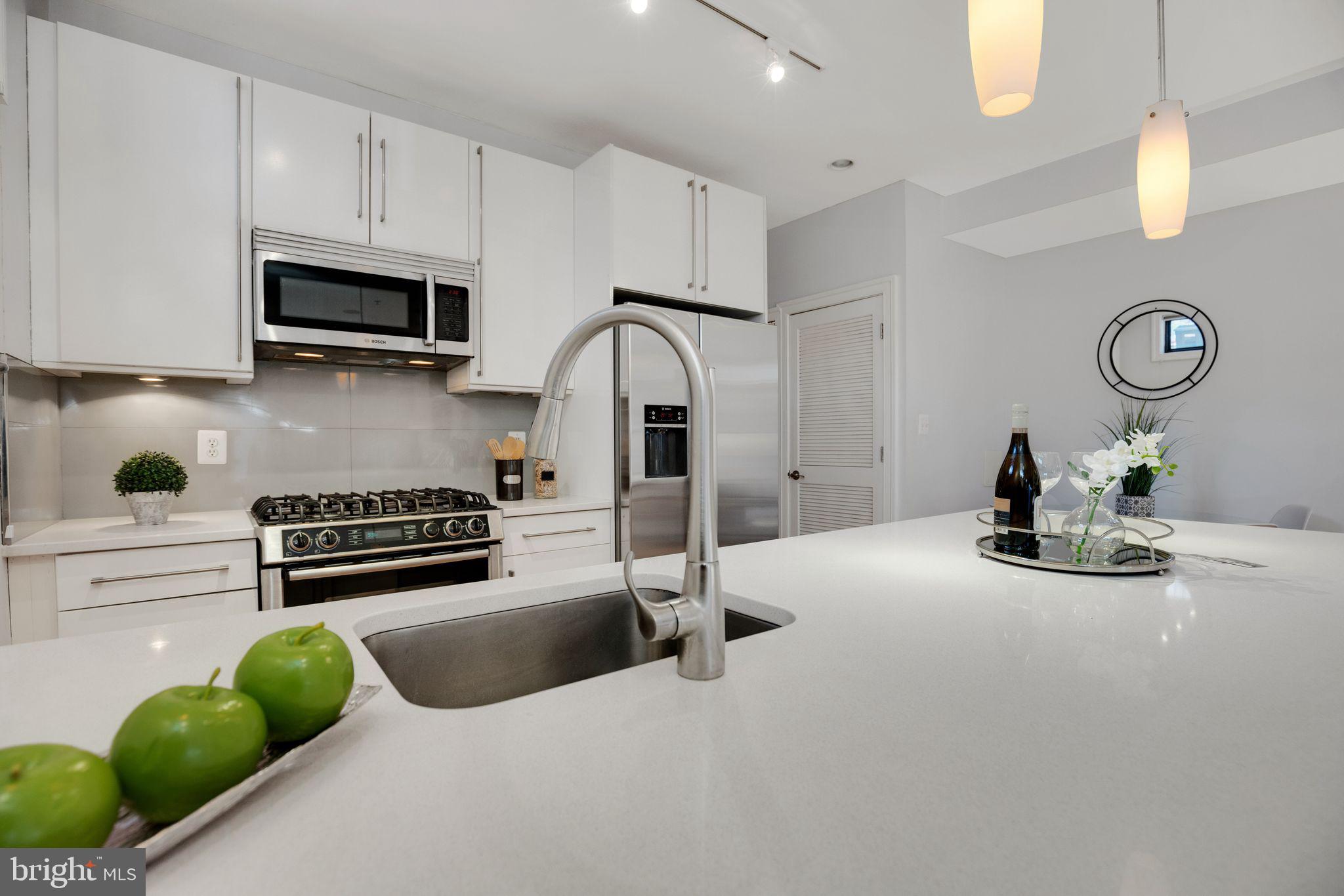 2106 10th Street Northwest, Unit 1 Washington, DC 20001 - Photo 17 of 31 a kitchen with stainless steel appliances granite countertop a sink a stove and cabinets